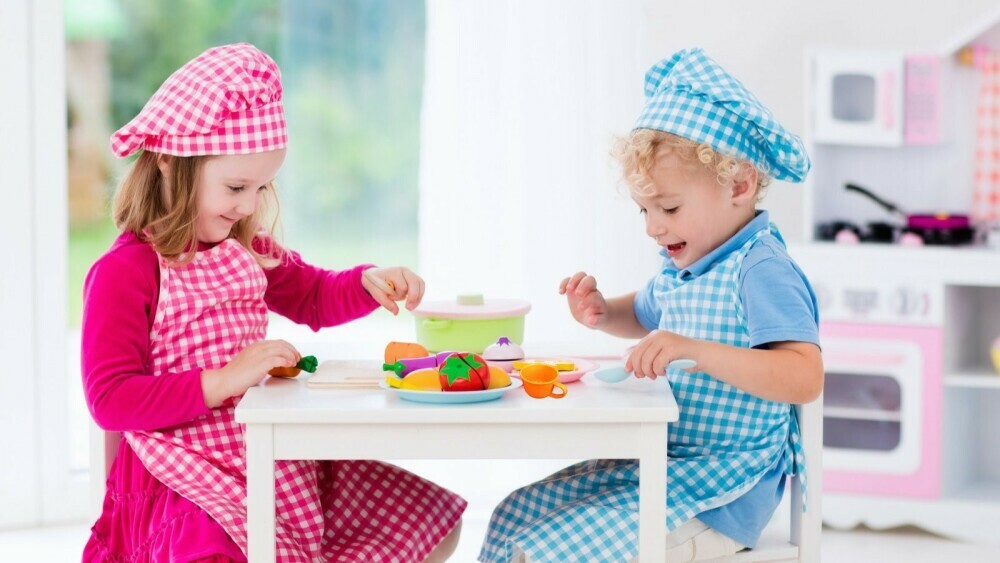 young children playing with kitchen toys