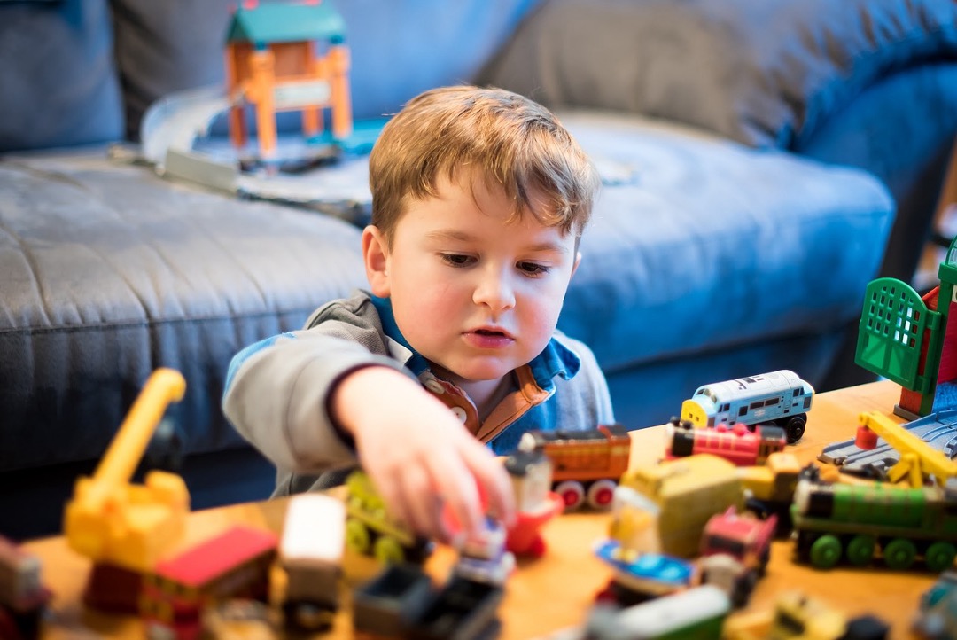 a child playing with diverse set of toys. Educational Toys For Children With Diverse Abilities.